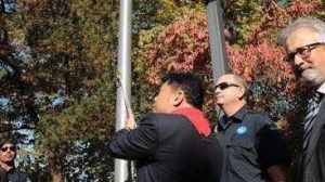 kerry jang raising flag at Vancouver City Hall